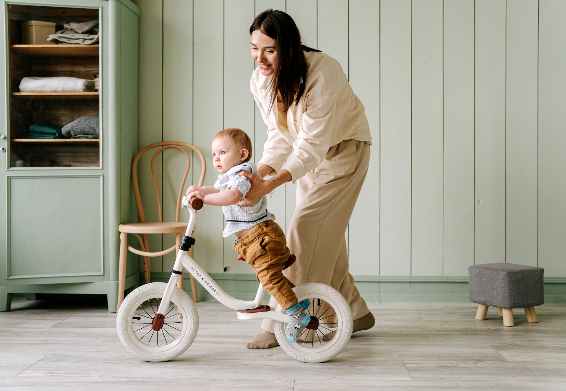 a baby biking inside the house